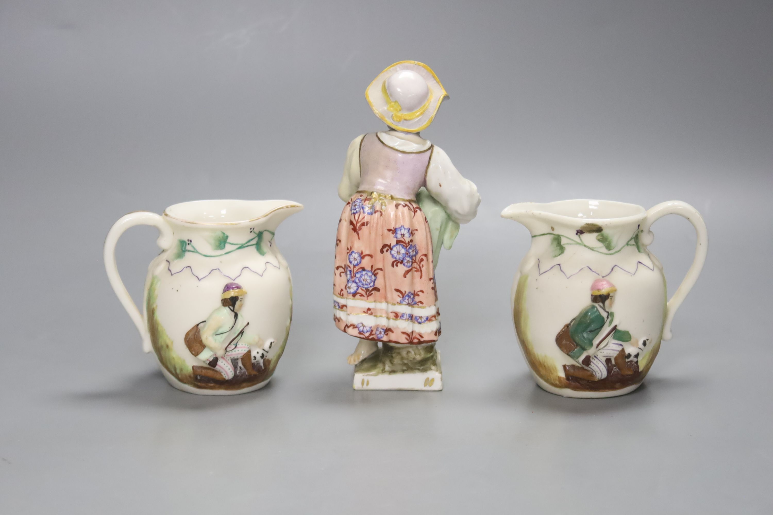 A 19th century Berlin figure, 14cm high and two small jugs